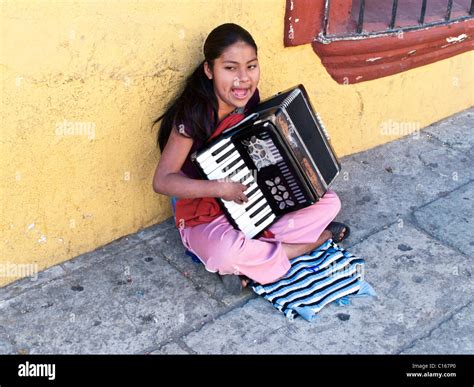 indigenous Mexican teenage teen girl sitting on sidewalk against ...