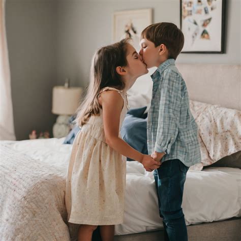 Siblings kiss in bedroom by Micah Betzner - Playground
