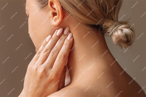Premium Photo | Inflamed tonsillar lymph nodes. young woman touches enlarged lymph nodes under ...