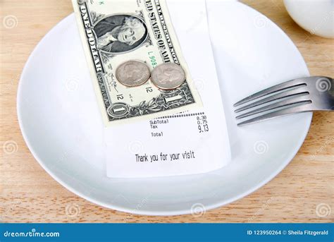 Gratuity tip on a plate stock photo. Image of order - 123950264