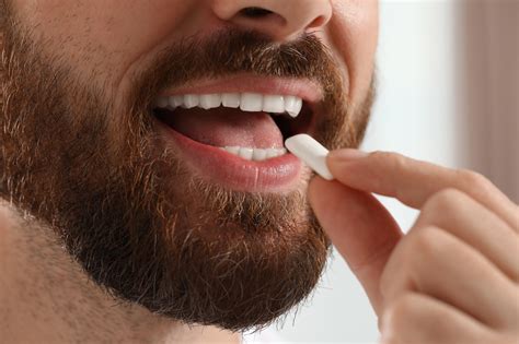 What are the benefits of chewing gum beyond oral health?