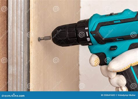 The Master Uses an Electric Screwdriver To Attach the Drywall To the ...