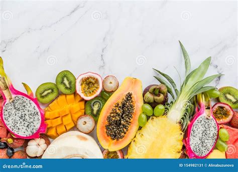 Fresh Exotic Fruits and Tropical Palm Leaves on White Marble Background ...