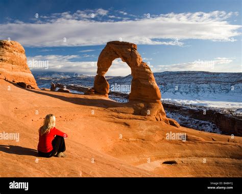 Girl viewing Delicate arch at sunset in Arches National Park, Utah, USA ...