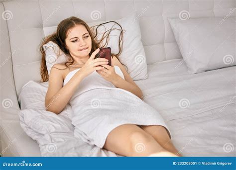 Elegant Naked Woman Lies in Bed with Mobile Phone. Stock Image - Image ...