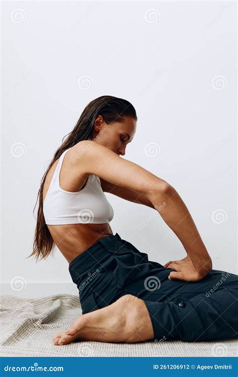 Woman Poses Sitting on Her Knees on the Floor with Beautiful Tanned ...