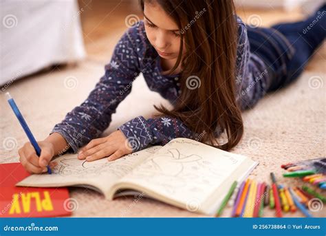 Every Child is an Artist. a Young Girl Coloring while Lying on the ...
