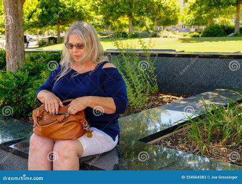 Elderly Woman Sitting on a Park Bench Looking at Her Purse Stock Image - Image of white, mature ...