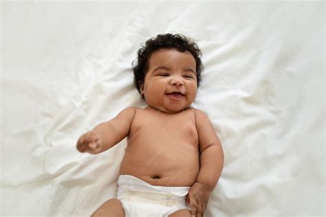 Premium Photo | Laughing cute african american small curly baby in ...