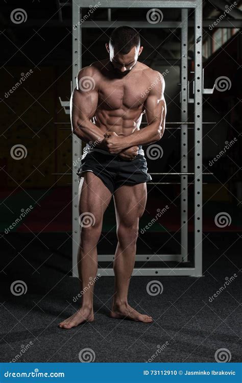 Handsome Body Builder Making Most Muscular Pose Stock Photo - Image of ...