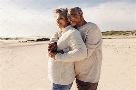 Mature couple enjoying a view of the ocean at the beach | People Images ...