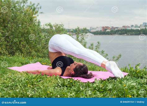 Fit Woman Making Yoga in Plow Pose on Mat in Nature. Stock Photo ...