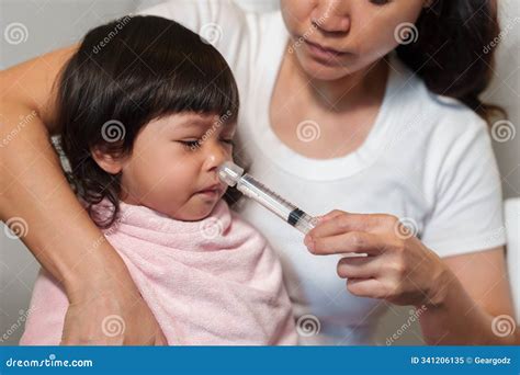 Mother Making Nasal Wash for Toddler with Syringe and Saline. Cleaning ...