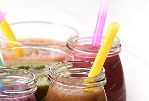 Premium Photo | Assorted fruit and vegetable shakes on white table