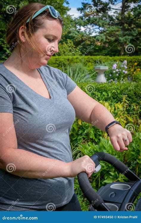 Young Mom Pushing Stroller and Tracking Exercise on Smartwatch Stock ...