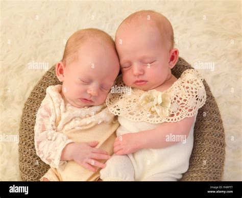 Three weeks old newborn identical twin babies dressed in lace Stock ...