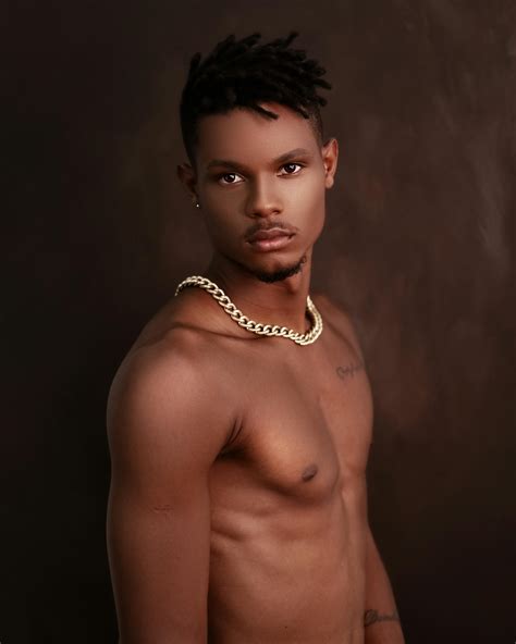 Naked black man looking at camera against brown background · Free Stock ...