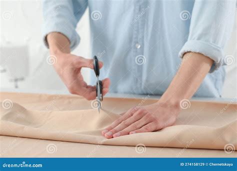 Dressmaker Cutting Fabric with Scissors at Table in Atelier, Closeup ...