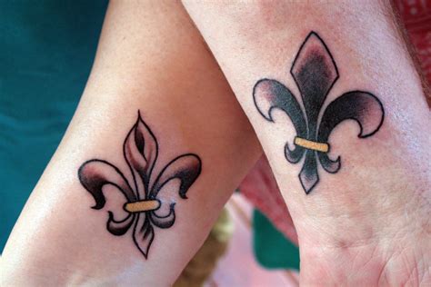 Matching Fleur-de-lis Tattoos on Forearms