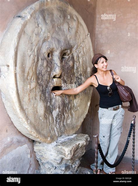 Woman with hand in Bocca della Verita Mouth of Truth Rome Lazio Italy ...