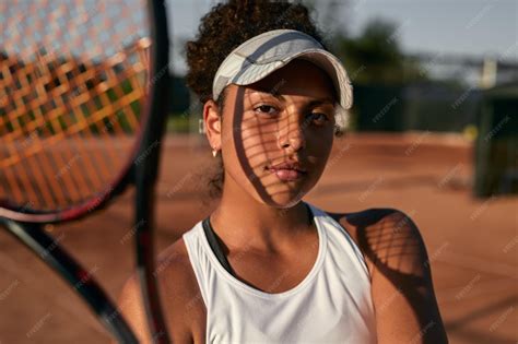 Premium Photo | African american tennis player on court in summer