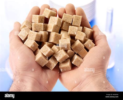 HANDFUL OF DEMERARA SUGAR CUBES Stock Photo - Alamy