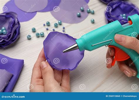 Woman with Hot Glue Gun Making Craft at Wooden Table, Closeup Stock ...
