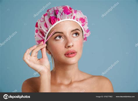Shirtless Young Woman Wearing Shower Cap Doing Makeup Isolated Blue ...