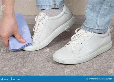 Cleaning White Shoes, Caring for Sneakers. a Woman Wipes Her Leather ...