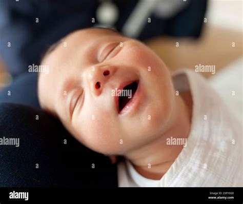 Portrait of sleeping newborn baby girl with smile Stock Photo - Alamy