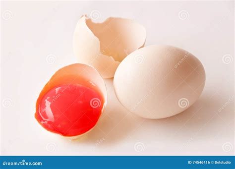 Broken egg with red yolk stock photo. Image of colourful - 74546416