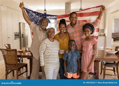 Multi-generation Family Holding an American Flag at Home Stock Image ...