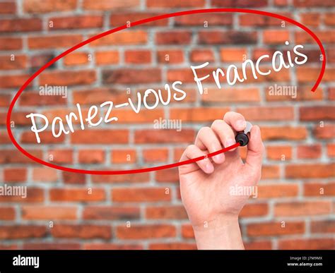 Man Hand writing Parlez-vous franĂ ?Ă‚Â§ais?(Do You Speak French? in ...