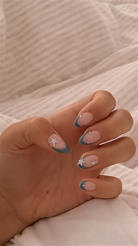Blue French tip almond nails with diamanté's and silver stars on both ...