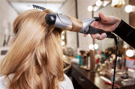 Premium Photo | Blonde girl in a beauty salon doing a hairstyle ...