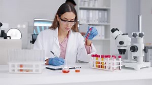 Female Scientist Analyzing Samples in a Laboratory