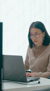 Vertical Screen : Young adult Asia female freelance eyeglasses typing write prompt AI bot app smart program nomad, video game, terminal coding, user interface, designer, big data center on computer.