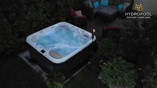 A cottage by a lake is a dream vacation only made better with a Hydropool hot tub so you can look at both your cottage and the lake!​ #wateriscalling #hydropool #hottub #cottageweekends | Valley Pool & Spa