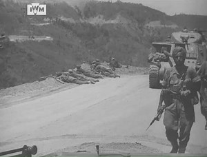 Sikh infantry walk by the camera while soldiers take up position on the cliffside during the Battle of Imphal, 1944. Read more about the battle here: bit.ly/47jzIic © IWM MWY 21 | Imperial War Museum London