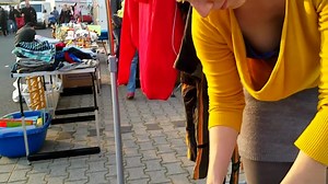 Street market seller has her big cleavage caught on the camera