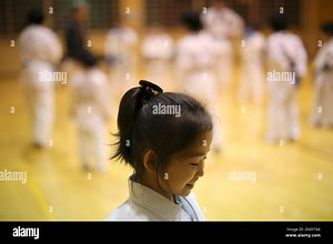 In this Nov. 18, 2015 photo, 9-year-old Mahiro Takano, three-time Japan karate champion in her age group smiles during her karate practice in Nagaoka, Niigata Prefecture, north of Tokyo. Mahiro stars in singer Sia’s latest music video “Alive,” the just-released single from the singer’s upcoming album. She has a soft spot for Duffy the Disney Bear and her favorite food is chocolate. She does her homework before dinner, but what she really loves are skateboarding, playing video games and bouncing 
