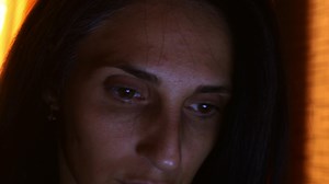 Download Close up beautiful brunette caucasian brown eye woman look at screen work online ar night alone in illuminated room. Work at night late for free