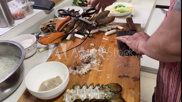 Preparing a live Shanghai hairy crab at home, with a cook cutting the crab using a large cleaver on a wooden cutting board to remove the meat from the hard shell before steaming in a kitchen setting.