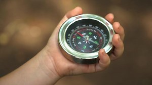 Hand Holding A Big Compass