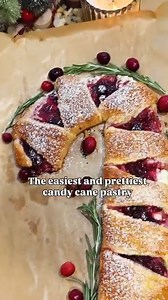 The Easiest and Prettiest Candy Cane Pastry✨ Ingredients: -1 package of Pillsbury Crescents -Whipped Cream Cheese (or regular cream cheese but warmed up a tiny bit) -Cranberry Sauce (or your favorite jam) -1 egg, beaten -Powdered Sugar ‌ Directions: 1. Line the baking sheet with parchment paper. 2. Layer crescent triangles to slightly overlap each other. 3. Add the cream cheese to the thicker parts of the dough and spread it out. Then add sauce/jam and spread it over the cream cheese. 4. Fold ov