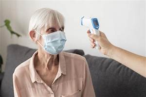 Free Photo Older Woman Her Temperature Checked With Thermometer