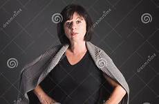 mature hips hands woman haired lo portrait dark older sweater stock her