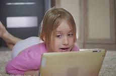 girl little lying playing computer floor tablet happy pc stock footage