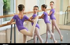 teen ballerina dancers stretching exercises