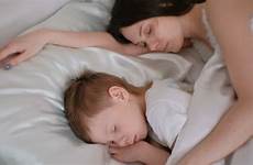 son mom sleeping together shutterstock
